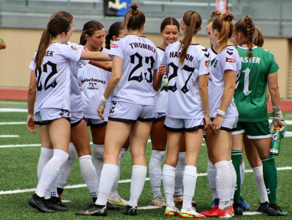 A group of FC Milwaukee Torrent players huddled in conversation during a match
