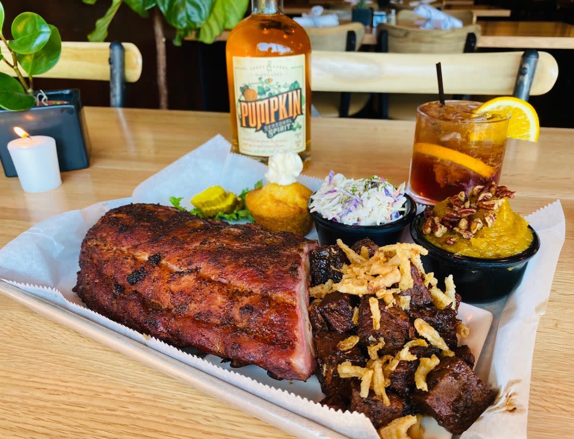 A rack of ribs and assorted BBQ food with traditional southern sides and a cocktail at Double B's BBQ