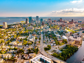 view of the Milwaukee skyline from a drone over Lake Michigan and the Milwaukee River