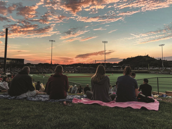 A group of fans looking out onto Franklin Field watching the Milwaukee Milkmen play baseball.