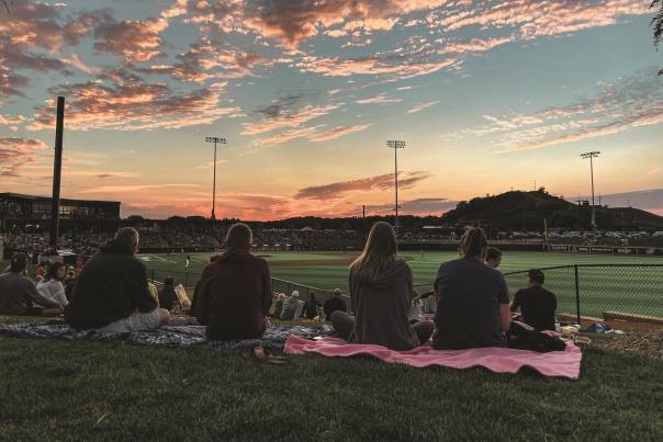 A group of fans looking out onto Franklin Field watching the Milwaukee Milkmen play baseball.