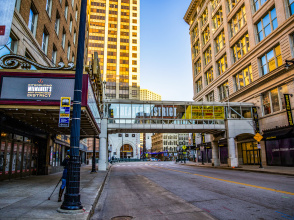 an image of a city street with a theater marquee and a skywalk with Milwaukee Theater District branding