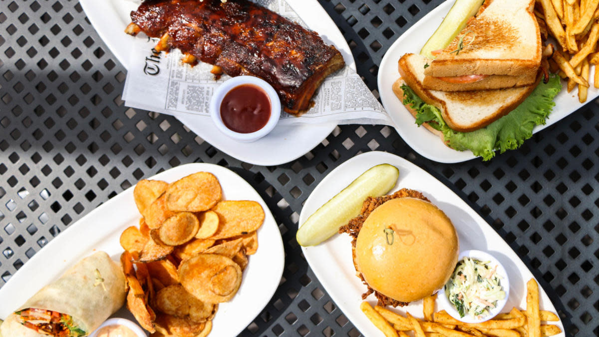 Assorted BBQ dishes on a patio table at Saz's State House Restaurant