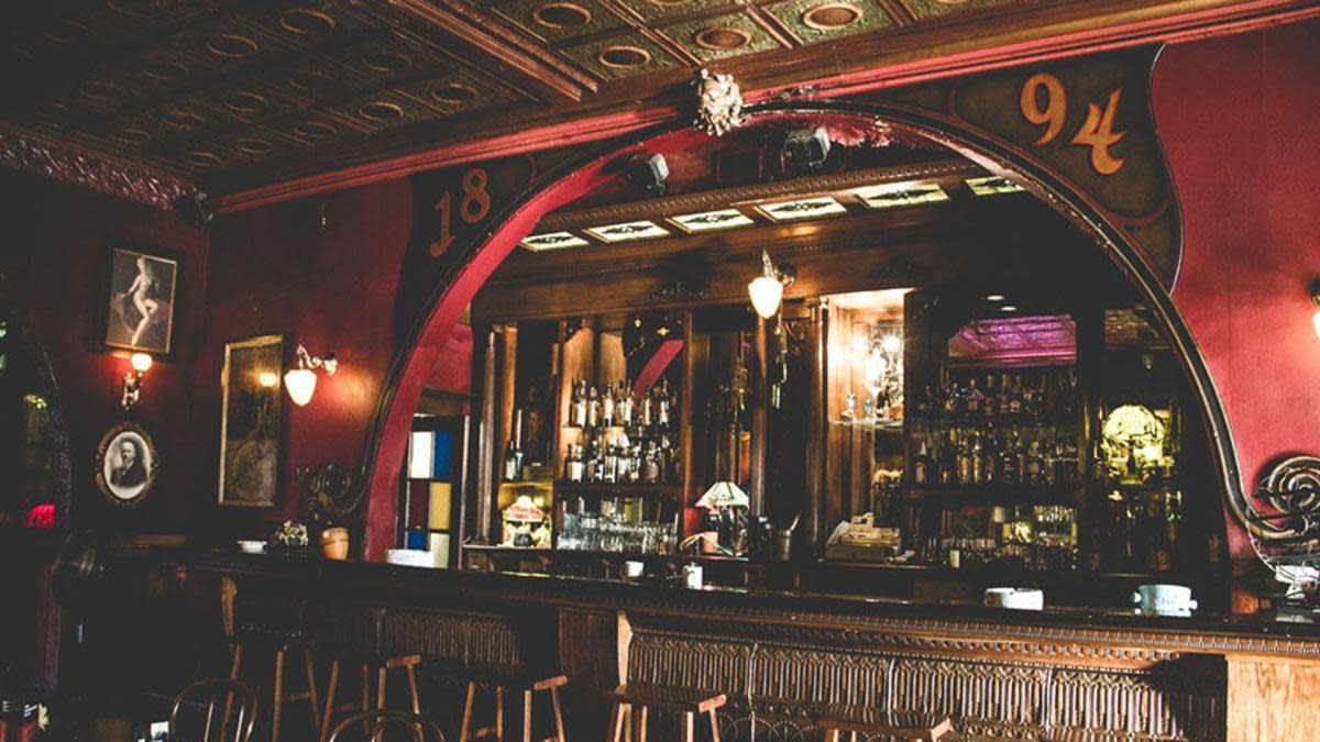 Dimly lit wood bar with red walls