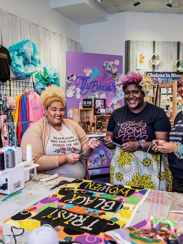 three women smiling in a store