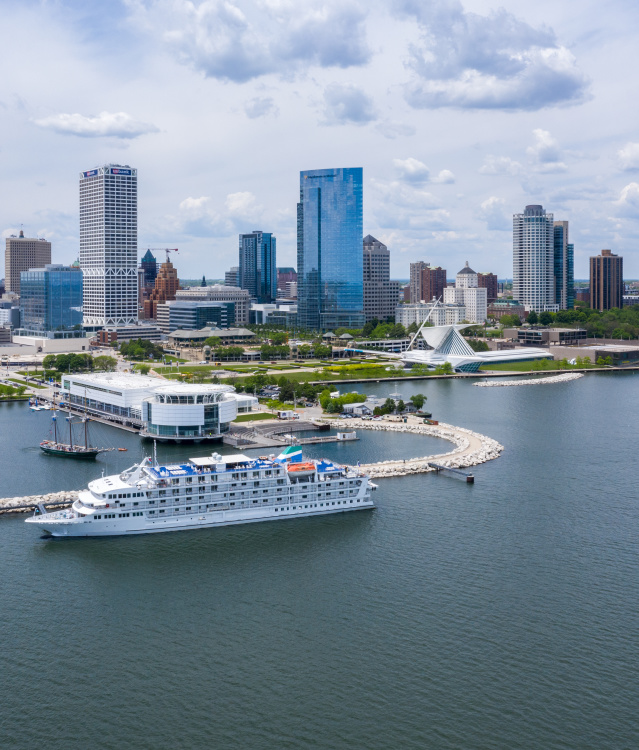 drone shot of the Pearl of the Mist Cruiseline in front of the Milwaukee skyline