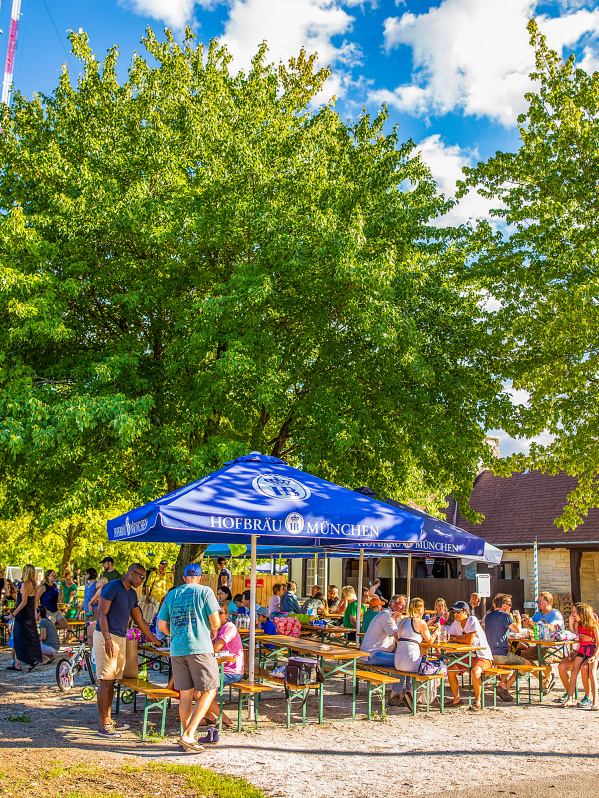 picnic tables filled with people in park