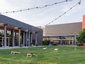 cornhole set up in the grass outside of Harley-Davidson Museum's the Garage