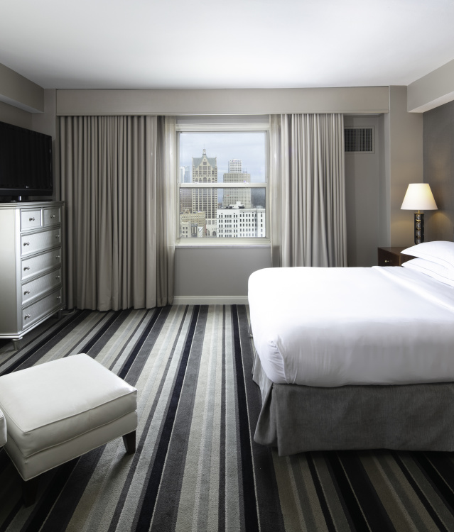 interior of a hotel room with Milwaukee Skyline prominent outside the window