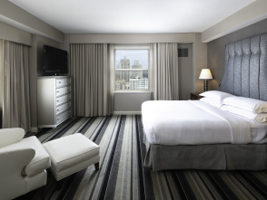 interior of a hotel room with Milwaukee Skyline prominent outside the window