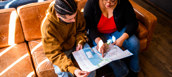 two people sitting on couch looking at the OVG map