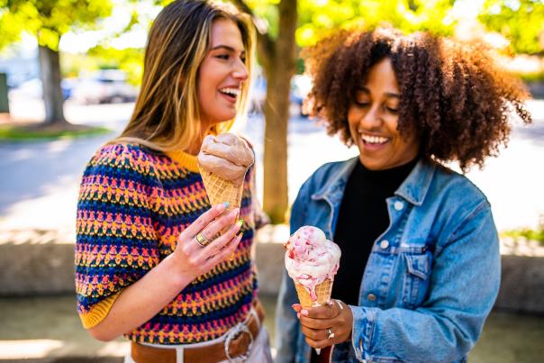 two women holding frozen custard and laughing