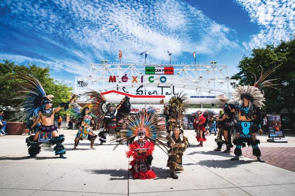 traditional Mexican dance in front of Mexican Fiesta festival grounds main gate