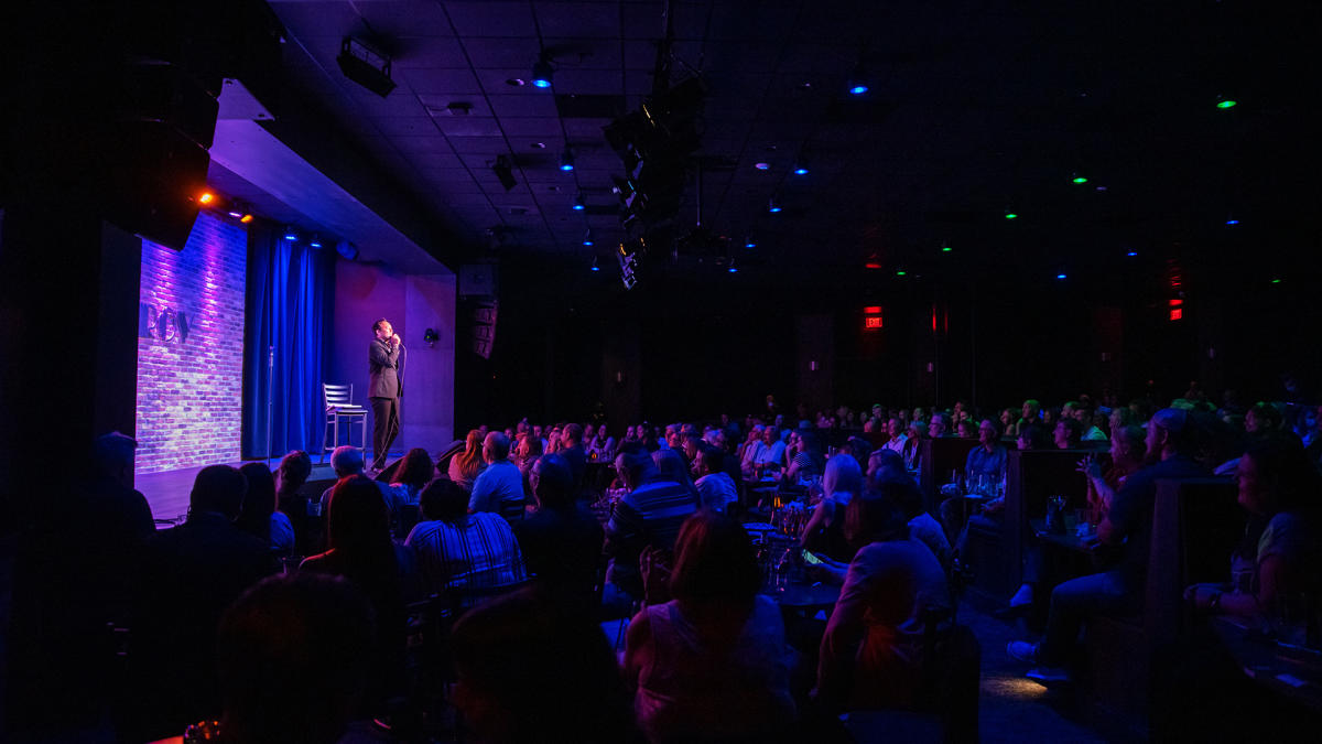 Improv performer on stage with audience