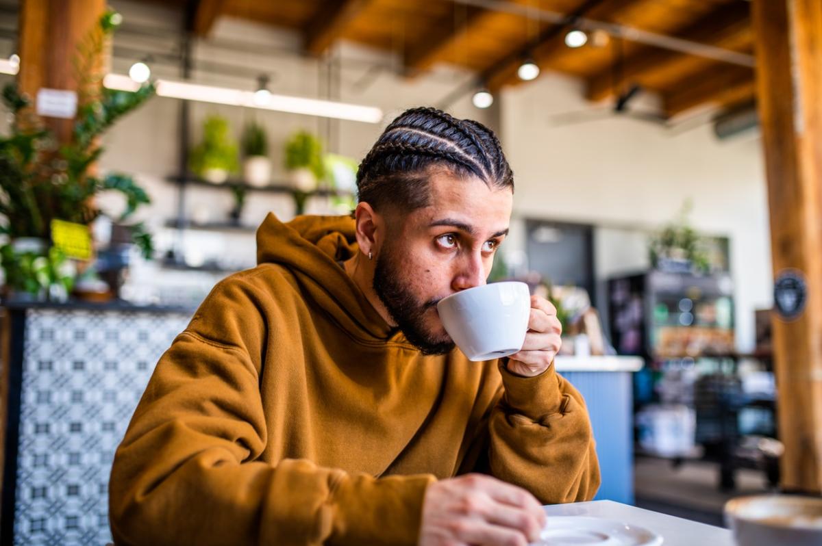 Man drinking coffee at Valentine Coffee Roasters