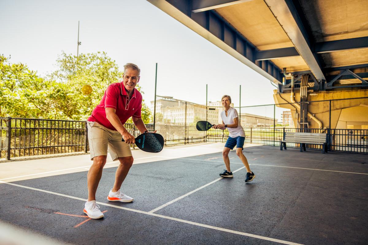 Couple playing pickleball at RiverWalk Commons