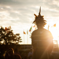 individual speaking into microphone with sunset behind