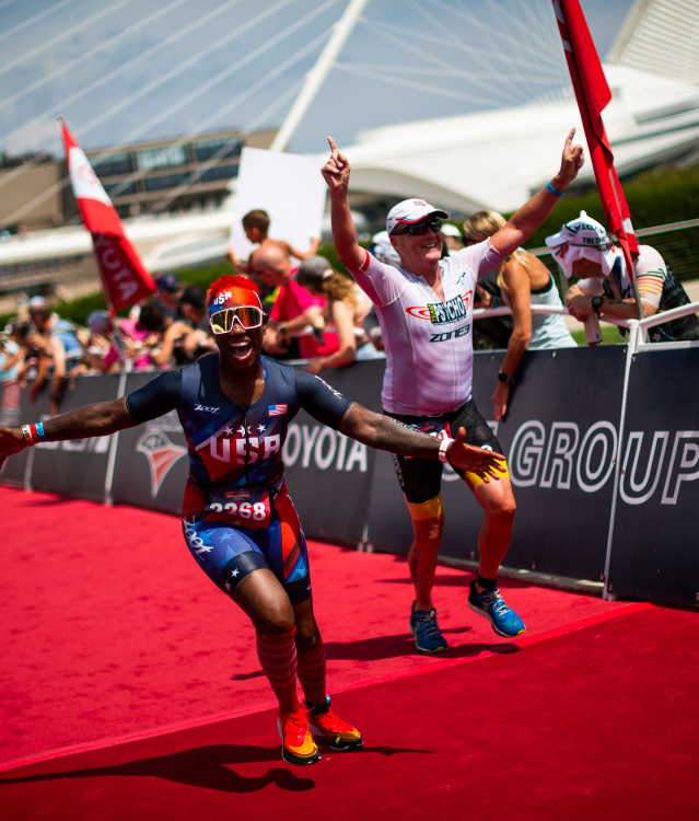 triathlete crossing the finish line in front of the Milwaukee Art Museum at the 2022 USA Triathalon