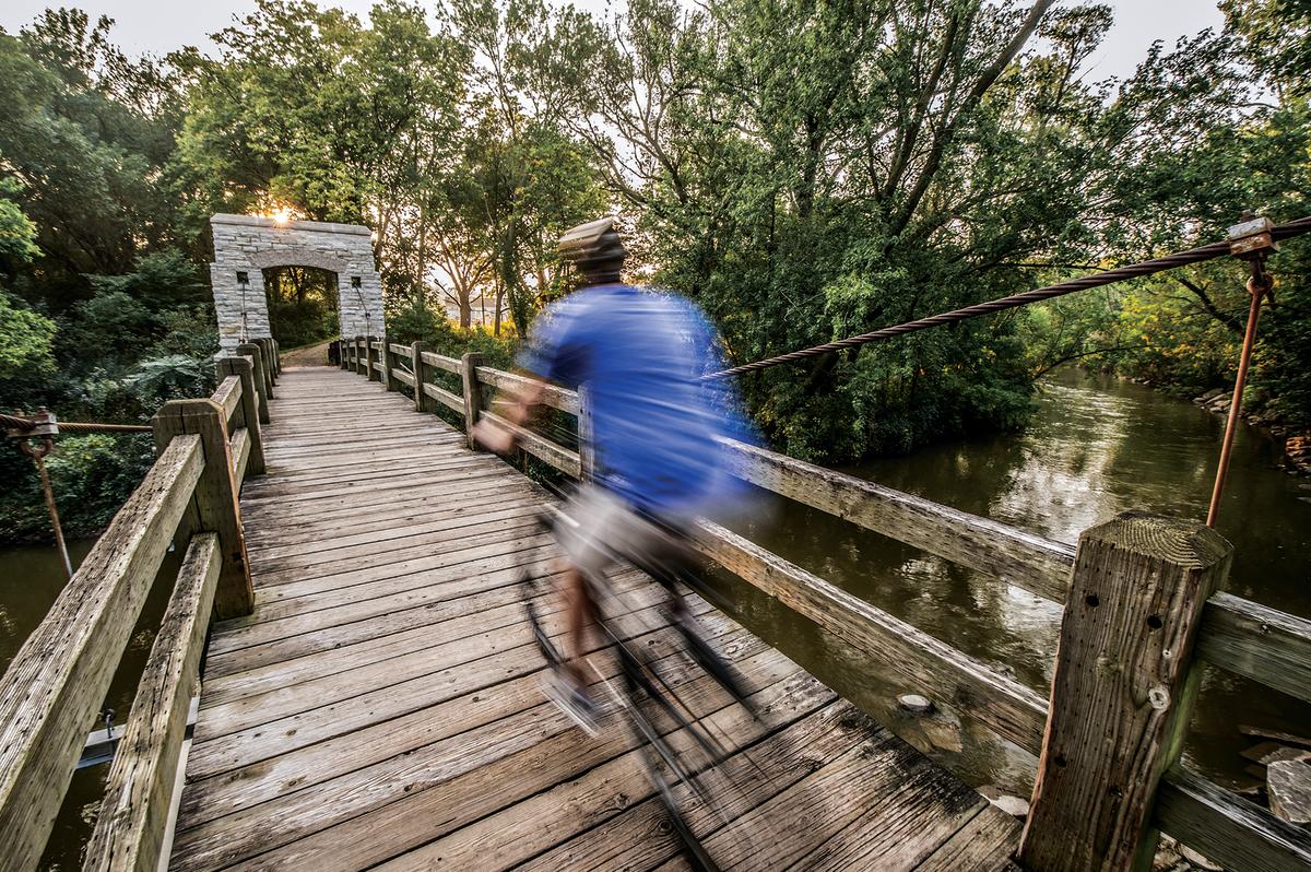 man biking over bridge in Hoyt Park