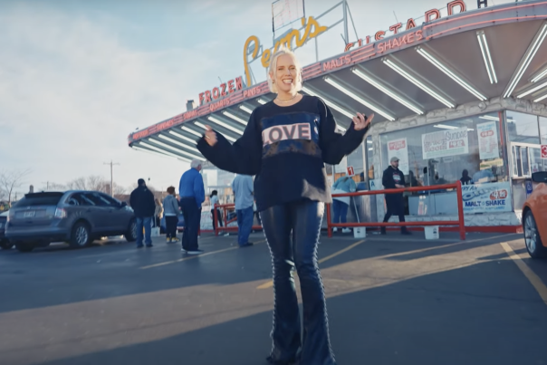 Grace Weber dancing in front of an old-style custard stand